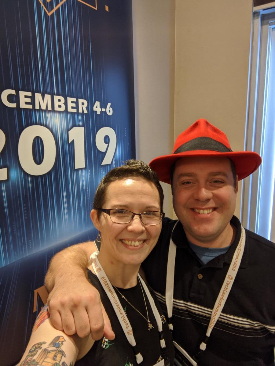 Us-ie (which is like a selfie) in front of the Tech Leader Summit sign